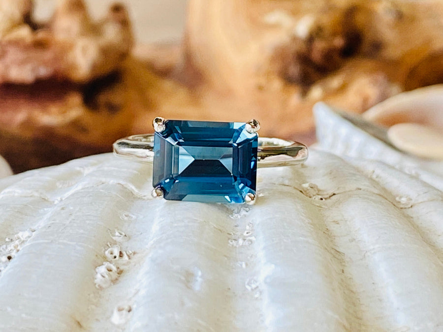 East West Emerald Cut London Blue Topaz Solitaire Ring