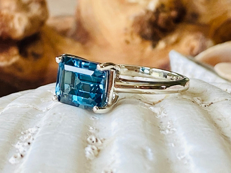 East West Emerald Cut London Blue Topaz Solitaire Ring