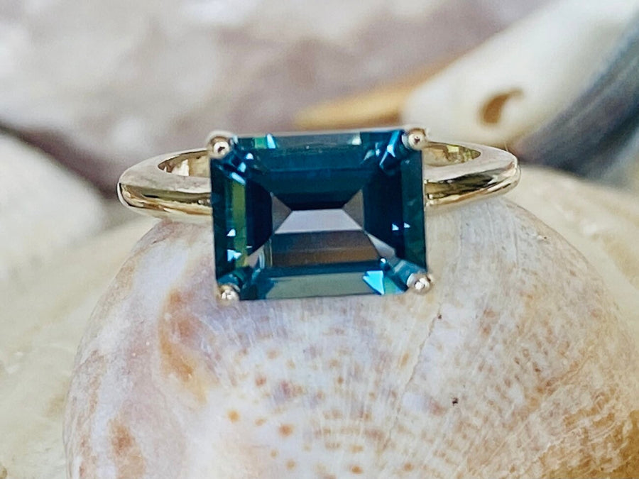 East West Emerald Cut London Blue Topaz Solitaire Ring